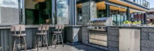 An outdoor kitchen on a sunny day outside a home