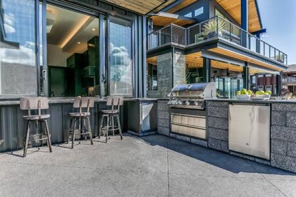 An outdoor kitchen on a sunny day outside a home