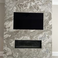 A marble fireplace surround from MC Granite Countertops.